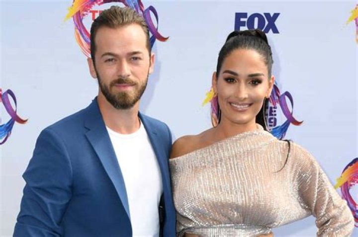 Pregnant Nikki Bella Flaunts Her Baby Bump and Shares a Sweet Smooch With Fiance Artem Chigvintsev