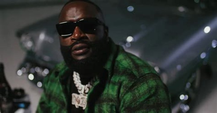 Rick Ross Blows Kisses & Comically Laughs At Drake In Music Video For "Champagne Moments"
